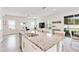 Open concept kitchen with granite island, breakfast bar seating, and easy access to the living area at 5514 Spanish Moss Cv, Bradenton, FL 34203