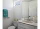 This powder room features a white vanity and light fixtures at 5526 River Sound Ter, Bradenton, FL 34208