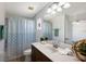 Neutral bathroom with large vanity, modern fixtures, and large mirror at 5526 River Sound Ter, Bradenton, FL 34208