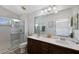 Bathroom with double sink vanity, tiled shower, and neutral decor at 5526 River Sound Ter, Bradenton, FL 34208