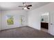 Bright bedroom with ensuite bathroom, vaulted ceiling, and balcony access at 5526 River Sound Ter, Bradenton, FL 34208