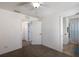 Bright bedroom features neutral carpeting, ceiling fan, and a bathroom with a blue shower curtain at 5526 River Sound Ter, Bradenton, FL 34208