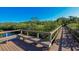 Wooden boardwalk with bench seating and green vegetation along the river at 5526 River Sound Ter, Bradenton, FL 34208
