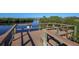 Wooden dock overlooking the water, with built-in benches and railings at 5526 River Sound Ter, Bradenton, FL 34208