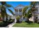 Charming two-story home featuring dual balconies and lush tropical landscaping at 5526 River Sound Ter, Bradenton, FL 34208