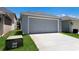 Attached two car garage with concrete driveway and manicured lawn at 5526 River Sound Ter, Bradenton, FL 34208