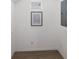 Bright hallway features wood-look floors, white walls, and a decorative art piece at 5526 River Sound Ter, Bradenton, FL 34208