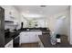 Bright kitchen with stainless steel appliances, white cabinets, and a breakfast bar at 5526 River Sound Ter, Bradenton, FL 34208