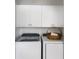 Bright laundry room features modern washer and dryer with storage cabinets at 5526 River Sound Ter, Bradenton, FL 34208