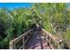 Nature trail featuring a wooden walkway surrounded by lush vegetation and trees at 5526 River Sound Ter, Bradenton, FL 34208