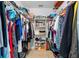 Walk-in closet with shelving and hanging space, filled with assorted clothing and storage items at 5603 Ravenwood Dr, Sarasota, FL 34243