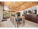 Elegant dining area with wood-paneled ceiling and view into kitchen through breakfast bar at 5603 Ravenwood Dr, Sarasota, FL 34243
