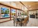 Sunroom featuring a dining table with views of the pool through large windows at 5603 Ravenwood Dr, Sarasota, FL 34243