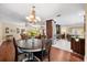 Open concept dining room featuring a chandelier, table for four, and views into the kitchen at 5603 Ravenwood Dr, Sarasota, FL 34243