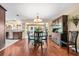 Elegant dining area with a wooden table, hutch, and hardwood floors, seamlessly connected to the kitchen at 5603 Ravenwood Dr, Sarasota, FL 34243