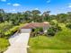 Charming single-story home with a manicured lawn and mature landscaping at 5603 Ravenwood Dr, Sarasota, FL 34243