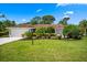 Well-maintained lawn and landscape in front of home at 5603 Ravenwood Dr, Sarasota, FL 34243