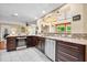 Gourmet kitchen featuring granite countertops, stainless steel appliances, wine cooler and tile floors at 5603 Ravenwood Dr, Sarasota, FL 34243