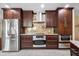 Bright kitchen with stainless steel refrigerator, modern range hood, and custom cabinetry at 5603 Ravenwood Dr, Sarasota, FL 34243