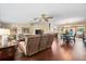 Open concept living room with hardwood floors, comfortable seating, an entertainment center, and a nearby dining area at 5603 Ravenwood Dr, Sarasota, FL 34243