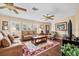 Comfortable living room with a large sofa, decorative rug, hardwood flooring and natural light from the windows at 5603 Ravenwood Dr, Sarasota, FL 34243