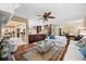 Open living room with hardwood floors, stylish rug, white sofas, and seamless flow into the kitchen at 5603 Ravenwood Dr, Sarasota, FL 34243