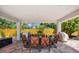 Inviting outdoor dining with ample seating, built-in grill, and peaceful views of the fenced backyard at 5603 Ravenwood Dr, Sarasota, FL 34243