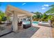 View of the pool and lanai, featuring an outdoor dining area, a grill, and a patio, perfect for relaxing and entertaining at 5603 Ravenwood Dr, Sarasota, FL 34243