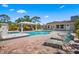 The backyard boasts a pool, a gazebo with dining area, and comfortable lounge chairs, set in a brick-paved patio at 5603 Ravenwood Dr, Sarasota, FL 34243