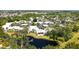 Scenic aerial shot showcasing condo buildings nestled among trees alongside a tranquil lake at 564 Lakeside Dr # 564, Bradenton, FL 34210
