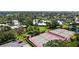Aerial view of community residences and tennis courts bordered by water and lush green space and trees at 564 Lakeside Dr # 564, Bradenton, FL 34210