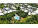 Aerial view of community residences surrounding a pool and jacuzzi with lush tropical landscaping and manicured green space at 564 Lakeside Dr # 564, Bradenton, FL 34210