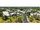 Aerial view of residences along a street with lush tropical landscaping and manicured green space and trees at 564 Lakeside Dr # 564, Bradenton, FL 34210