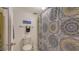 The bathroom has a vibrant patterned shower curtain, a toilet, and complementary towel decor at 564 Lakeside Dr # 564, Bradenton, FL 34210