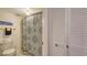 The bathroom has a vibrant patterned shower curtain, a toilet, and complementary closet space at 564 Lakeside Dr # 564, Bradenton, FL 34210