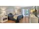 Comfortable bedroom with a walkout to a porch, hardwood floors, and ample natural light at 564 Lakeside Dr # 564, Bradenton, FL 34210