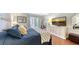 Comfortable bedroom featuring a cozy bed, a sleek TV atop a stylish white dresser, and a bright workspace at 564 Lakeside Dr # 564, Bradenton, FL 34210