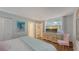 The bedroom is equipped with sleek storage, a comfortable bed, and a scenic TV view for relaxation at 564 Lakeside Dr # 564, Bradenton, FL 34210