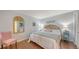 The bedroom is illuminated with soft lighting, accentuated by a decorative mirror and cozy pink seating at 564 Lakeside Dr # 564, Bradenton, FL 34210