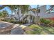Exterior view of condo building with stairs, sidewalk and well-manicured landscaping at 564 Lakeside Dr # 564, Bradenton, FL 34210