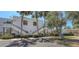 Exterior view of condo building with palm trees and well-manicured landscaping at 564 Lakeside Dr # 564, Bradenton, FL 34210