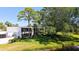 A well-manicured exterior view of a condo community featuring lush landscaping and a tranquil pond at 564 Lakeside Dr # 564, Bradenton, FL 34210