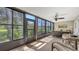 Enclosed lanai with floor-to-ceiling windows, ceiling fan and outdoor views at 564 Lakeside Dr # 564, Bradenton, FL 34210