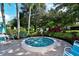 Inviting community hot tub nestled within tropical landscaping, creating a serene and private oasis at 564 Lakeside Dr # 564, Bradenton, FL 34210