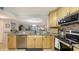 Open kitchen featuring granite countertops, stainless steel appliances, and seamless flow to living spaces at 564 Lakeside Dr # 564, Bradenton, FL 34210