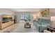 Bright living room featuring a comfortable blue couch and sliding doors to the lanai at 564 Lakeside Dr # 564, Bradenton, FL 34210