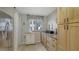 Cozy pantry with wood cabinets, granite countertops, natural light, and modern stainless refrigerator at 564 Lakeside Dr # 564, Bradenton, FL 34210
