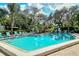 An inviting pool features clear blue water, surrounded by lush greenery, and lounge chairs for relaxation at 564 Lakeside Dr # 564, Bradenton, FL 34210