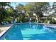 A serene pool surrounded by lush landscaping offers a refreshing retreat for relaxation and leisure at 564 Lakeside Dr # 564, Bradenton, FL 34210