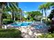 A beautiful community pool, surrounded by palm trees and lounge chairs, offers a perfect oasis at 564 Lakeside Dr # 564, Bradenton, FL 34210